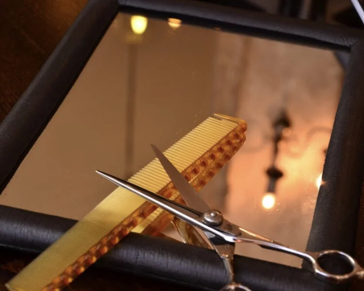 Professional barber tools on mirror - J Moriyama Hair Design